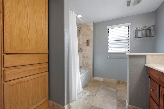 6814 68th Ave E, Bradenton, FL 34203 - full bathroom featuring vanity, shower / bath combination with curtain, and stone finish floors