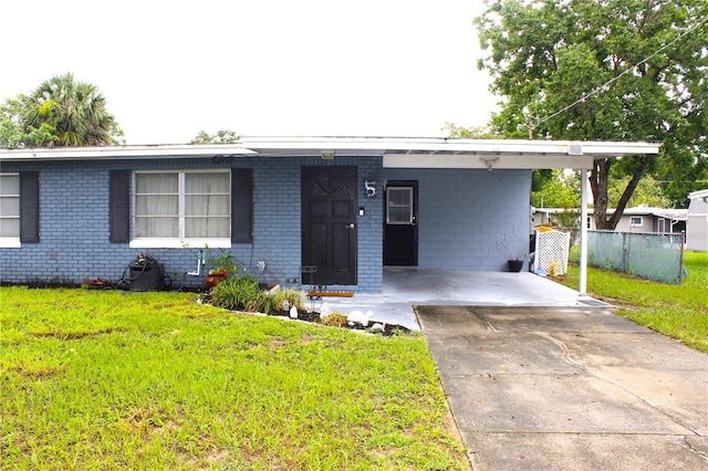 5 Moonlight Ln, Winter Haven, FL 33884 - single story home with concrete driveway, an attached carport, and brick siding