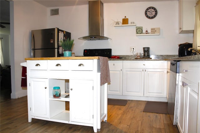 5 Moonlight Ln, Winter Haven, FL 33884 - kitchen with island exhaust hood, freestanding refrigerator, open shelves, white cabinetry, and wood finished floors