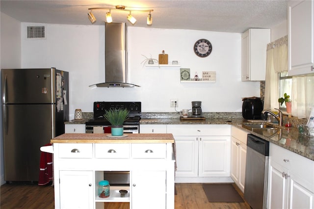 5 Moonlight Ln, Winter Haven, FL 33884 - kitchen with stainless steel appliances, wall chimney exhaust hood, white cabinets, and dark wood-style floors
