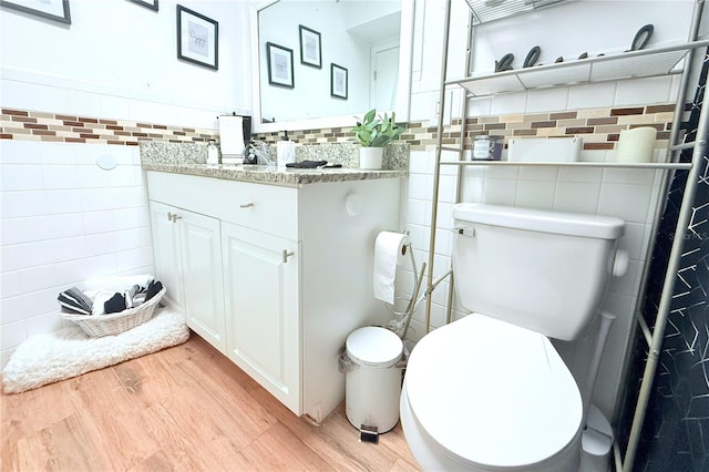 5 Moonlight Ln, Winter Haven, FL 33884 - bathroom with tile walls, wood finished floors, vanity, and wainscoting