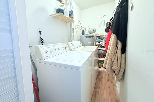 5 Moonlight Ln, Winter Haven, FL 33884 - washroom featuring washer and dryer, light wood-style floors, and water heater