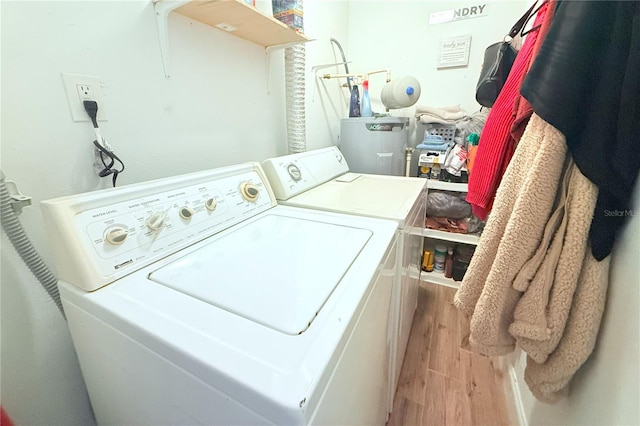 5 Moonlight Ln, Winter Haven, FL 33884 - laundry room featuring wood finished floors, washing machine and clothes dryer, and water heater