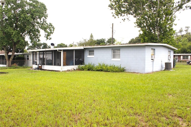 5 Moonlight Ln, Winter Haven, FL 33884 - rear view of house featuring a sunroom and concrete block siding