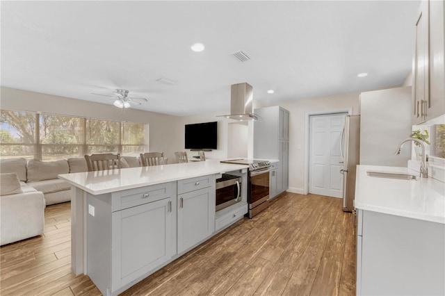 9819 Allen Rd, Lithia, FL 33547 - kitchen featuring island range hood, open floor plan, stainless steel appliances, a peninsula, and recessed lighting