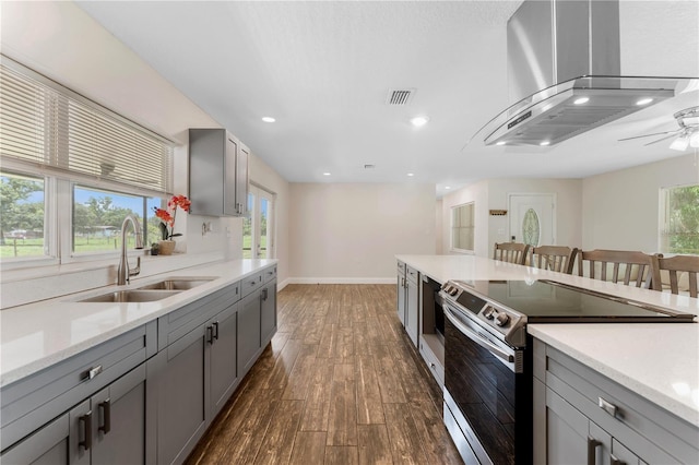 9819 Allen Rd, Lithia, FL 33547 - kitchen with stainless steel electric range, wall chimney range hood, gray cabinets, dark wood-type flooring, and recessed lighting