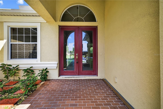 1835 Fircrest Ct, Wesley Chapel, FL 33543 - view of exterior entry with stucco siding and french doors
