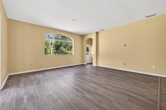 1835 Fircrest Ct, Wesley Chapel, FL 33543 - unfurnished room featuring arched walkways and dark wood-type flooring