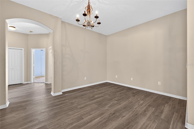 1835 Fircrest Ct, Wesley Chapel, FL 33543 - unfurnished room featuring arched walkways, dark wood-style floors, and a chandelier