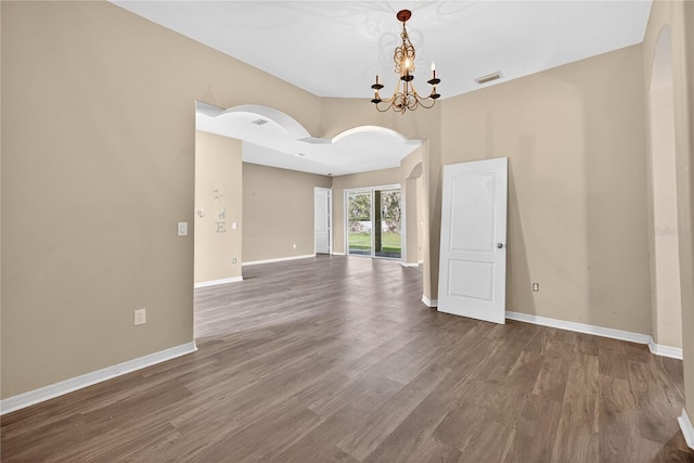 1835 Fircrest Ct, Wesley Chapel, FL 33543 - empty room with a chandelier, wood finished floors, and arched walkways