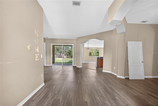 1835 Fircrest Ct, Wesley Chapel, FL 33543 - unfurnished living room with arched walkways and dark wood-style flooring