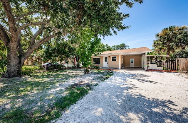 8184 49th Ave N, Saint Petersburg, FL 33709 - ranch-style home featuring gravel driveway and a carport