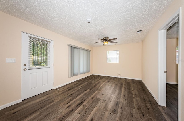8184 49th Ave N, Saint Petersburg, FL 33709 - unfurnished room with dark wood finished floors, a textured ceiling, and a ceiling fan