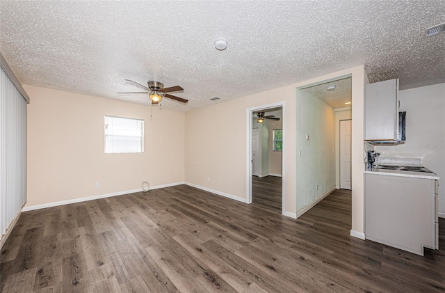 8184 49th Ave N, Saint Petersburg, FL 33709 - unfurnished room featuring ceiling fan, a textured ceiling, and dark wood finished floors