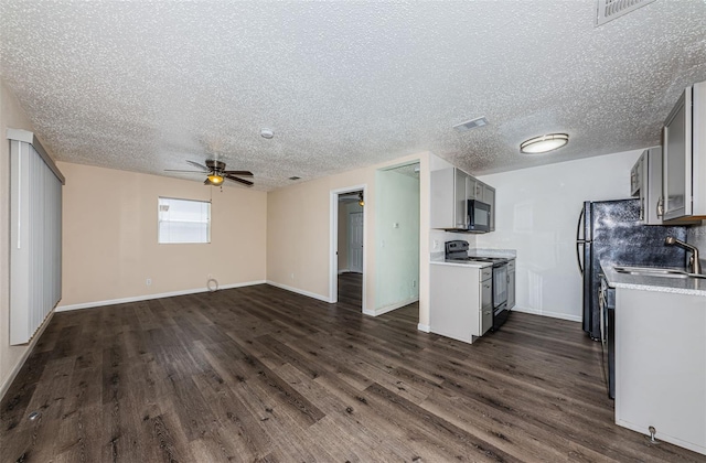 8184 49th Ave N, Saint Petersburg, FL 33709 - kitchen featuring electric range, black microwave, a ceiling fan, dark wood-type flooring, and a textured ceiling