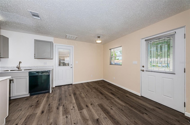 8184 49th Ave N, Saint Petersburg, FL 33709 - kitchen featuring black dishwasher, dark wood-type flooring, a textured ceiling, light countertops, and gray cabinetry