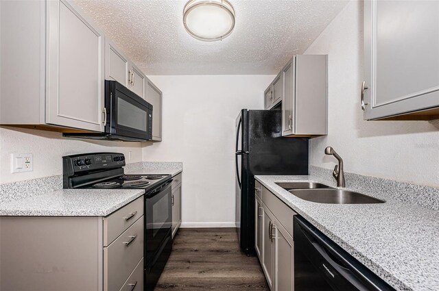 8184 49th Ave N, Saint Petersburg, FL 33709 - kitchen featuring black appliances, gray cabinets, dark wood-style flooring, and a textured ceiling
