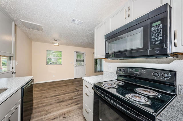 8184 49th Ave N, Saint Petersburg, FL 33709 - kitchen with black appliances, wood finished floors, a textured ceiling, and white cabinetry
