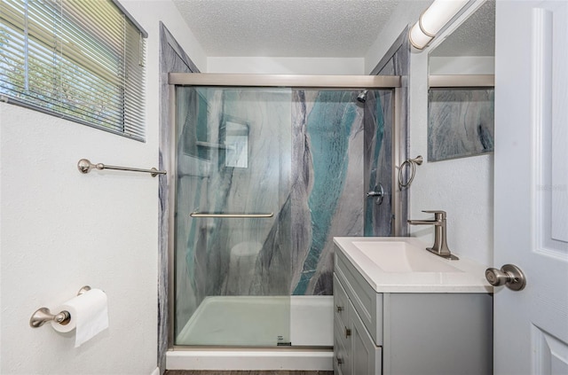 8184 49th Ave N, Saint Petersburg, FL 33709 - full bathroom with vanity, a stall shower, and a textured ceiling