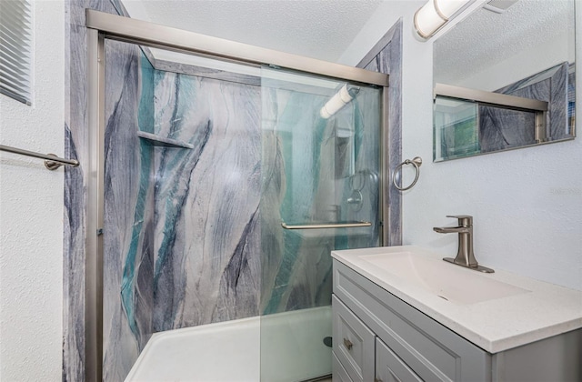 8184 49th Ave N, Saint Petersburg, FL 33709 - full bathroom with a textured ceiling, vanity, and a marble finish shower