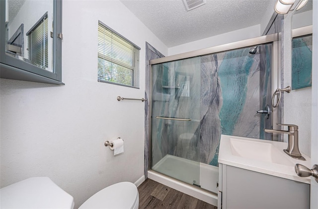 8184 49th Ave N, Saint Petersburg, FL 33709 - bathroom with wood finished floors, a stall shower, vanity, and a textured ceiling