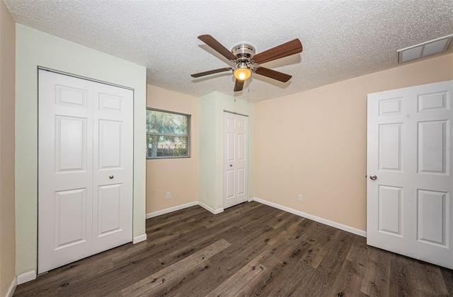 8184 49th Ave N, Saint Petersburg, FL 33709 - unfurnished bedroom with dark wood finished floors, a textured ceiling, and ceiling fan
