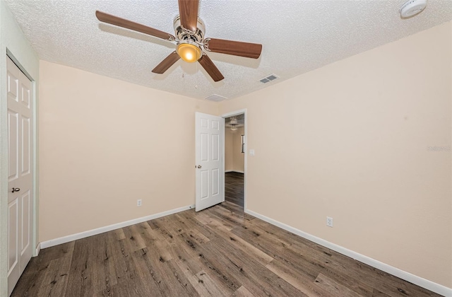 8184 49th Ave N, Saint Petersburg, FL 33709 - unfurnished bedroom featuring wood finished floors, a textured ceiling, and ceiling fan