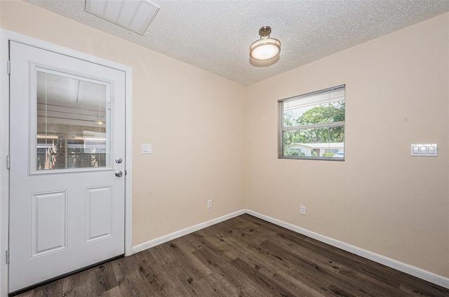 8184 49th Ave N, Saint Petersburg, FL 33709 - empty room with dark wood-type flooring and a textured ceiling