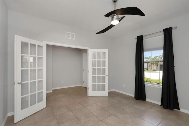 1613 Cabbage Key Dr, Ruskin, FL 33570 - empty room featuring french doors, light tile patterned floors, and a ceiling fan
