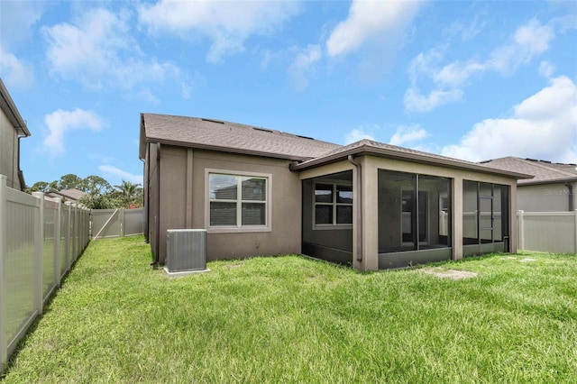 1613 Cabbage Key Dr, Ruskin, FL 33570 - back of house featuring a sunroom, a fenced backyard, stucco siding, and roof with shingles
