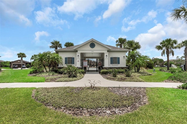 1613 Cabbage Key Dr, Ruskin, FL 33570 - view of front of property featuring stucco siding, a gate, and a fenced front yard