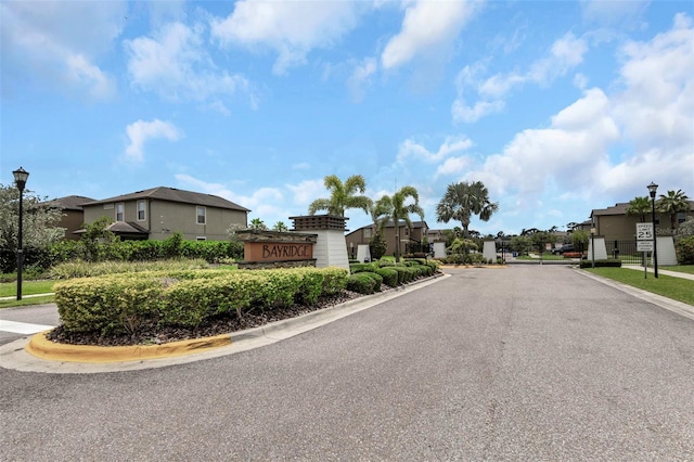 1613 Cabbage Key Dr, Ruskin, FL 33570 - view of asphalt road featuring street lights, curbs, a residential view, and a gated entry