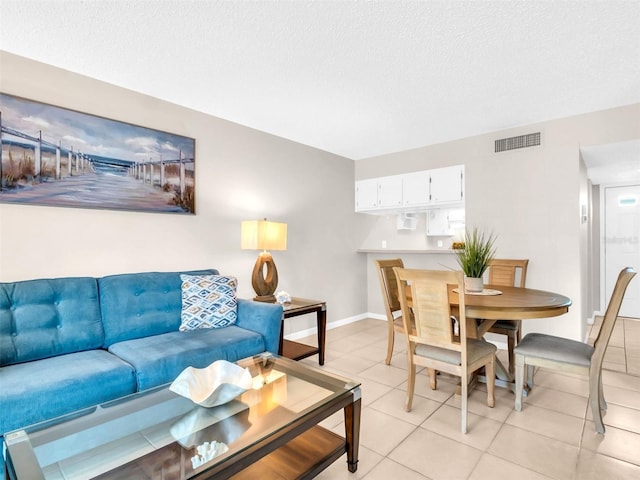401 Windrush Bay Dr, Tarpon Springs, FL 34689 - living room with light tile patterned floors and a textured ceiling