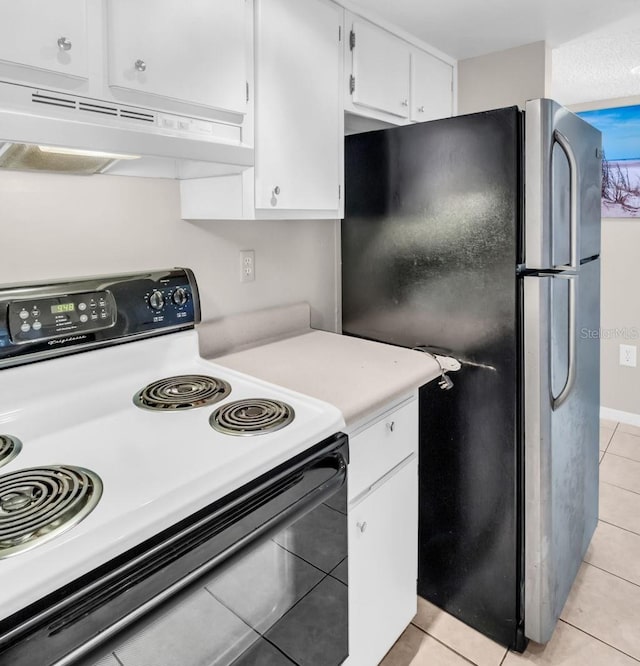 401 Windrush Bay Dr, Tarpon Springs, FL 34689 - kitchen featuring range with electric cooktop, freestanding refrigerator, light tile patterned flooring, light countertops, and under cabinet range hood