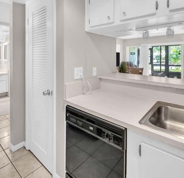 401 Windrush Bay Dr, Tarpon Springs, FL 34689 - kitchen with dishwasher, light tile patterned flooring, light countertops, and white cabinets