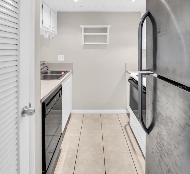 401 Windrush Bay Dr, Tarpon Springs, FL 34689 - kitchen featuring freestanding refrigerator, black dishwasher, white electric range, light tile patterned floors, and light countertops