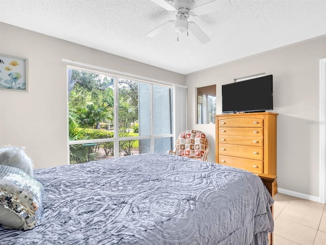 401 Windrush Bay Dr, Tarpon Springs, FL 34689 - bedroom featuring light tile patterned floors, a textured ceiling, and a ceiling fan