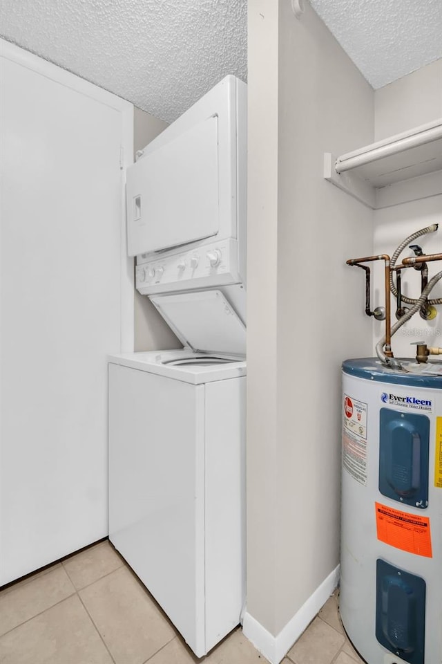 401 Windrush Bay Dr, Tarpon Springs, FL 34689 - laundry area with water heater, a textured ceiling, stacked washer / dryer, and light tile patterned floors