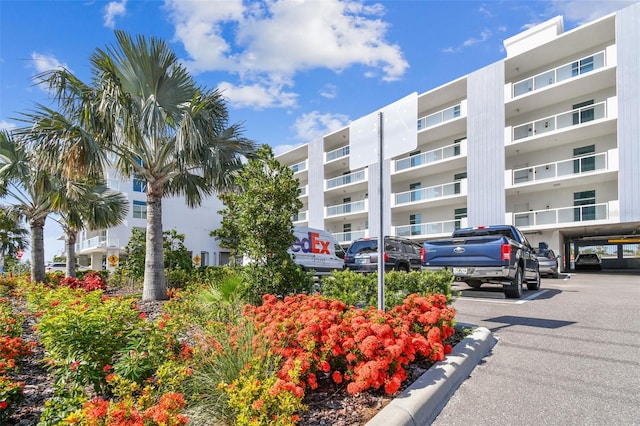 415 Island Way Unit 507, Clearwater Beach, FL 33767 - view of apartment building / complex featuring uncovered parking