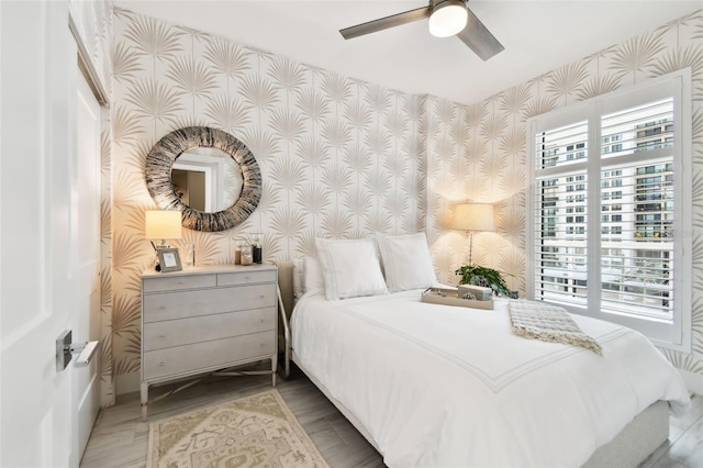 415 Island Way Unit 507, Clearwater Beach, FL 33767 - bedroom featuring wallpapered walls and a ceiling fan