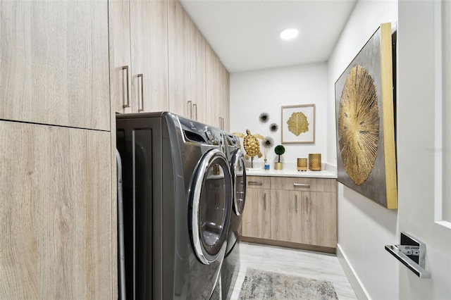 415 Island Way Unit 507, Clearwater Beach, FL 33767 - laundry area featuring washer and dryer, cabinet space, and light wood finished floors