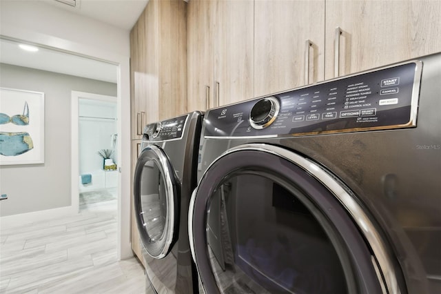 415 Island Way Unit 507, Clearwater Beach, FL 33767 - washroom featuring washing machine and clothes dryer and baseboards