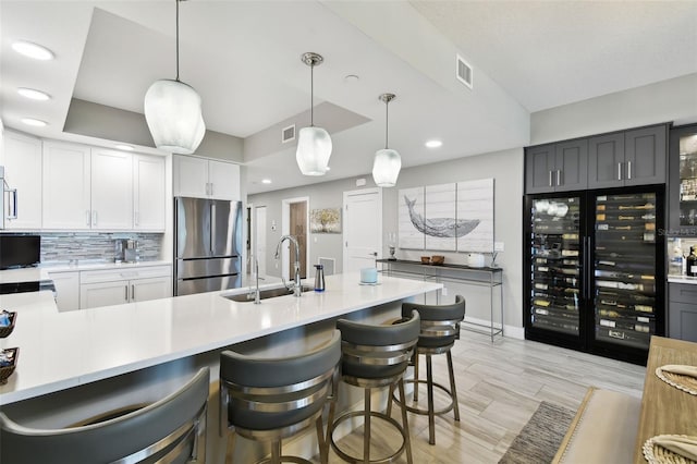 415 Island Way Unit 507, Clearwater Beach, FL 33767 - kitchen with freestanding refrigerator, light countertops, beverage cooler, recessed lighting, and pendant lighting