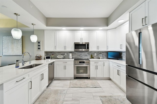 415 Island Way Unit 507, Clearwater Beach, FL 33767 - kitchen with stainless steel appliances, a peninsula, light countertops, light marble finish floors, and recessed lighting