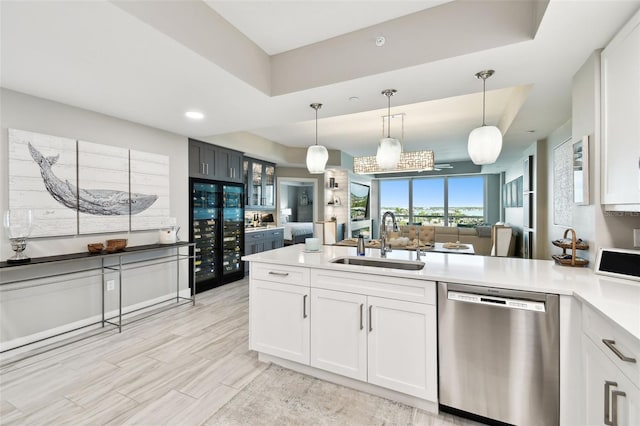 415 Island Way Unit 507, Clearwater Beach, FL 33767 - kitchen with stainless steel dishwasher, wine cooler, light countertops, a peninsula, and hanging light fixtures