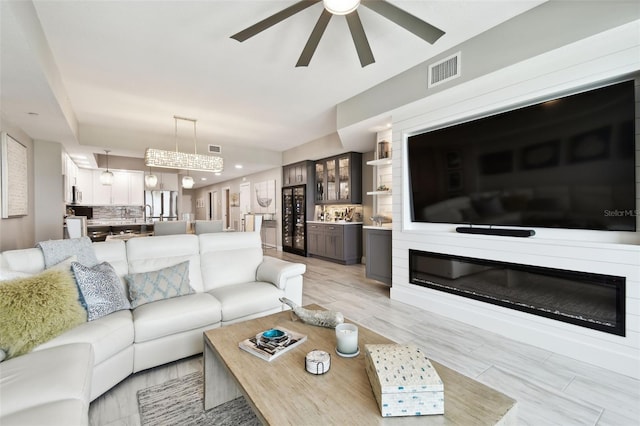 415 Island Way Unit 507, Clearwater Beach, FL 33767 - living area with ceiling fan, beverage cooler, a glass covered fireplace, and recessed lighting