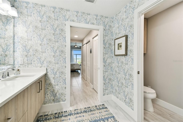 415 Island Way Unit 507, Clearwater Beach, FL 33767 - ensuite bathroom with vanity, wallpapered walls, and a ceiling fan