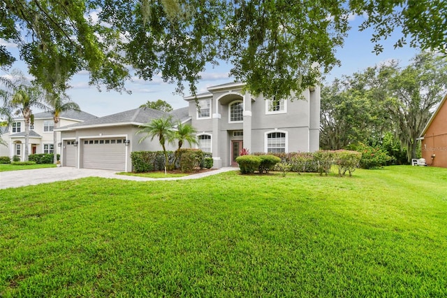 297 Beacon Pointe Dr, Ocoee, FL 34761 - view of front of home featuring an attached garage, a front yard, driveway, and stucco siding