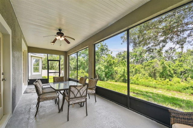 297 Beacon Pointe Dr, Ocoee, FL 34761 - sunroom featuring ceiling fan, outdoor dining space, and view of scattered trees