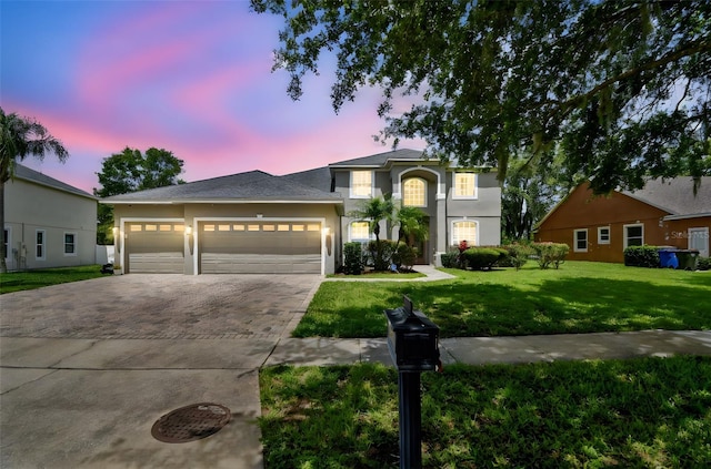 297 Beacon Pointe Dr, Ocoee, FL 34761 - traditional home featuring driveway, a lawn, an attached garage, and stucco siding